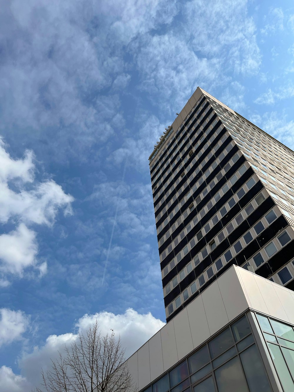 a tall building sitting next to a very tall building