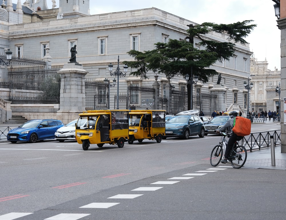a man riding a bike next to a yellow bus