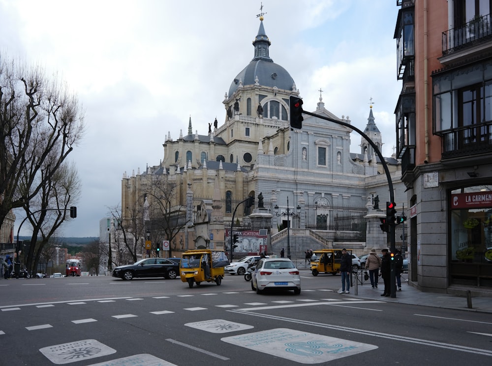 a busy city street with a large building in the background