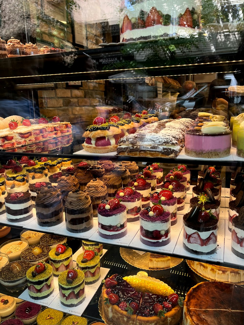 a display case filled with lots of cakes and pies