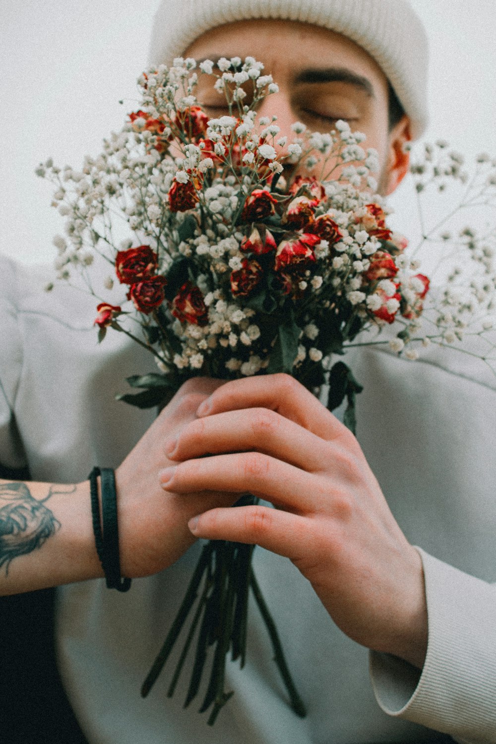 ein Mann, der einen Blumenstrauß in den Händen hält