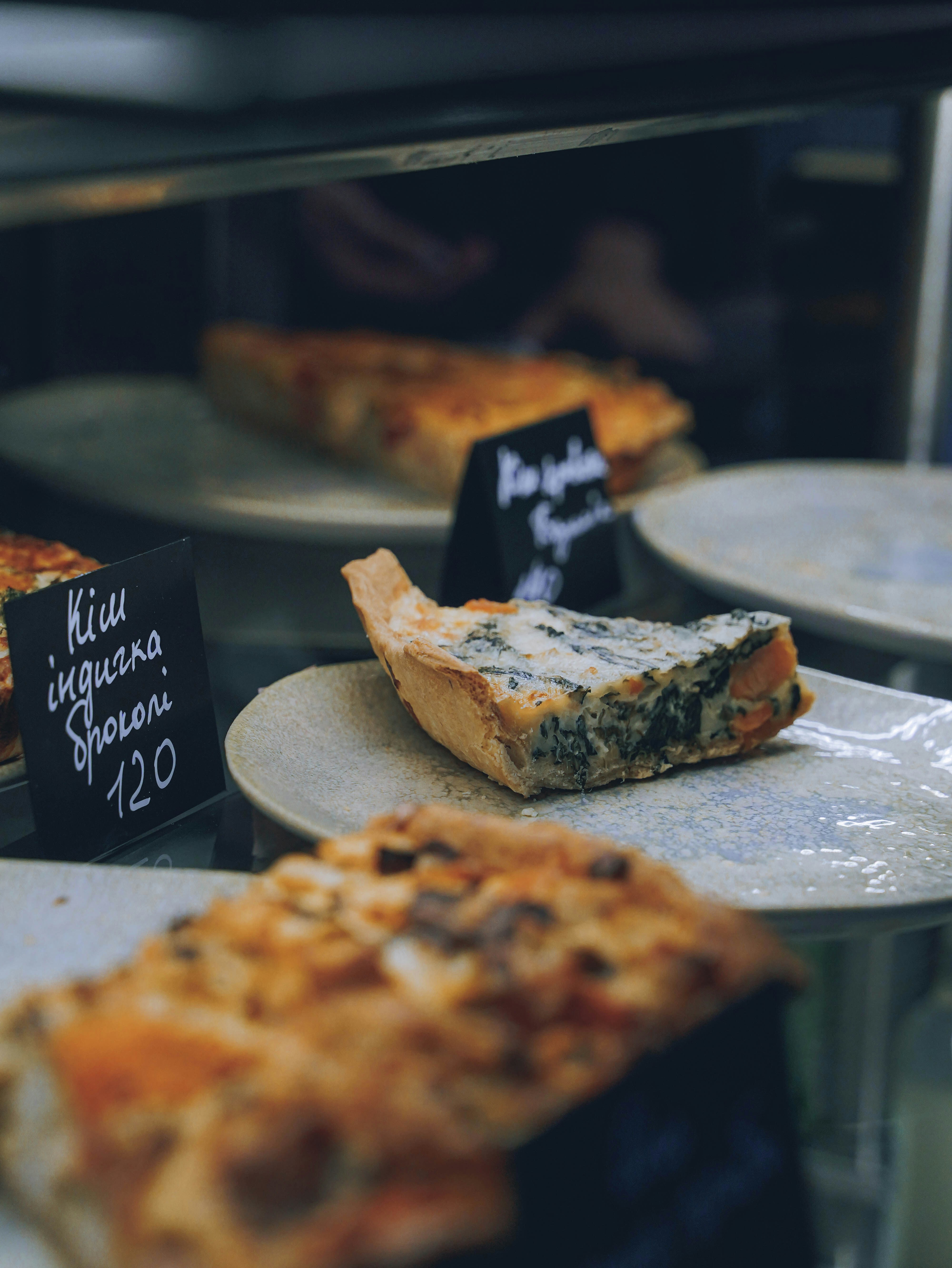 a display case filled with lots of different types of pizza
