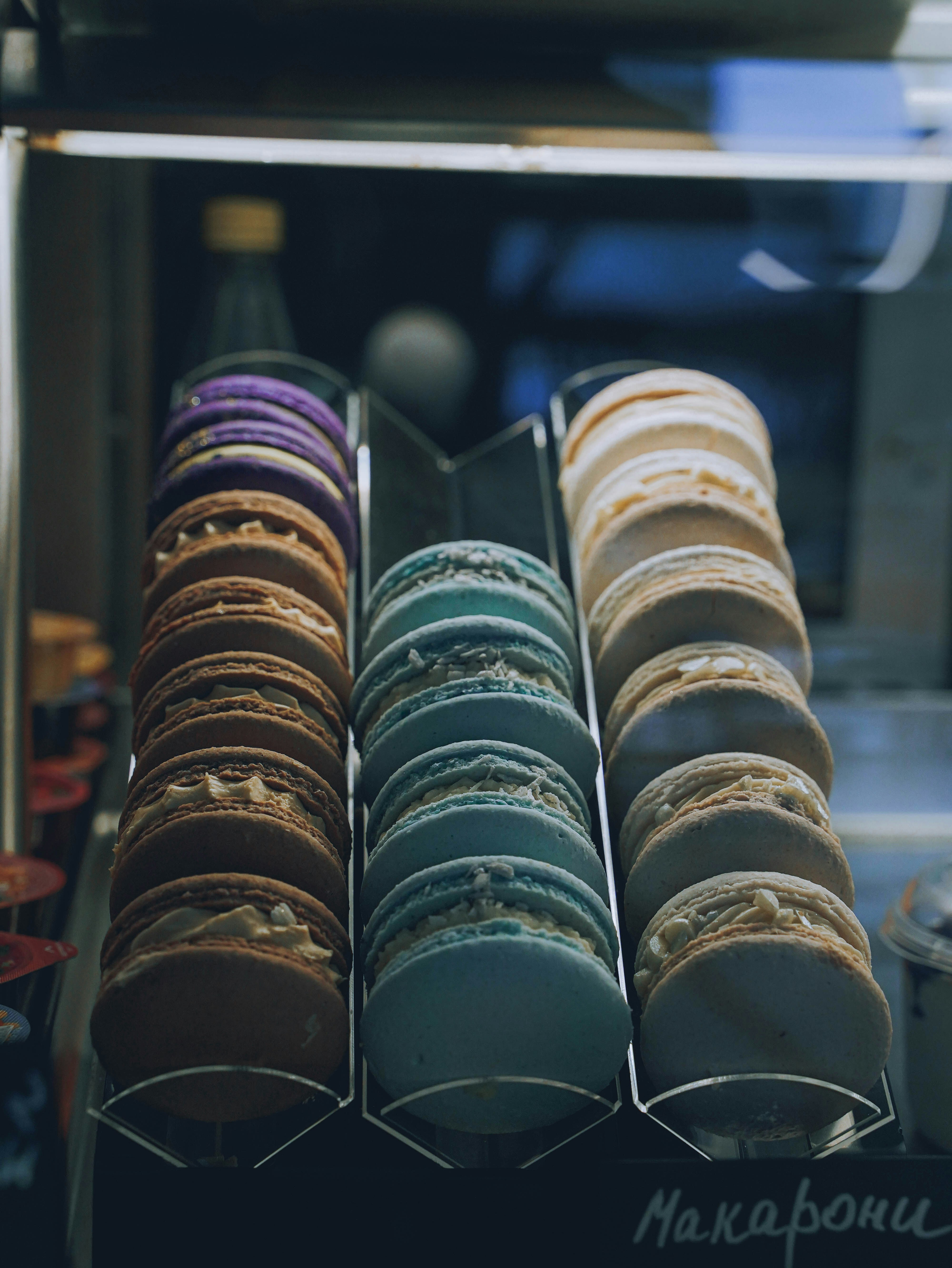 a display case filled with lots of different colored donuts