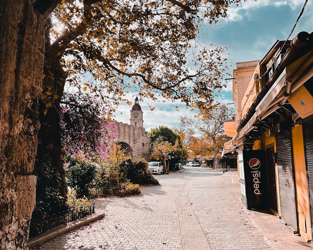 a city street with a clock tower in the background