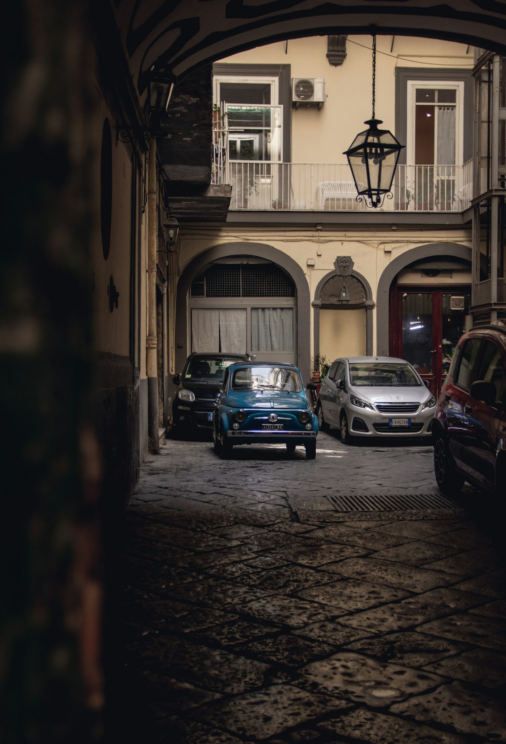 a couple of cars that are parked in front of a building