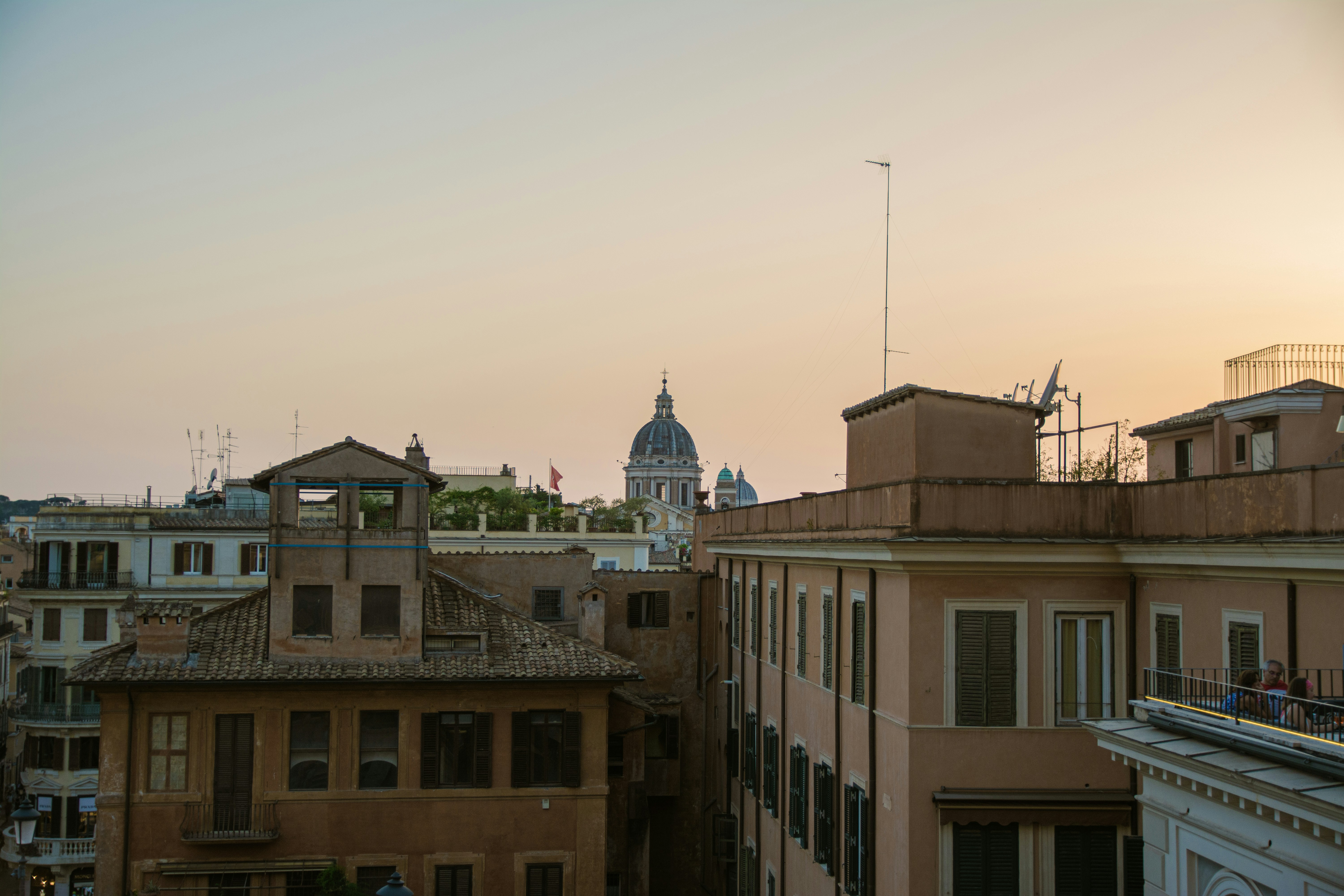 a view of a city from a rooftop at sunset
