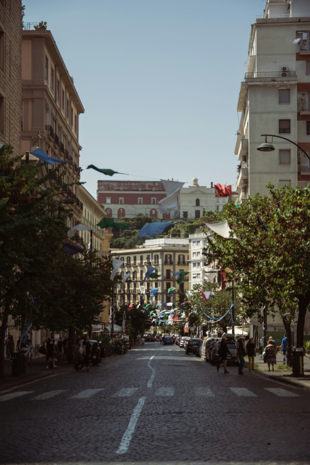 a city street with people walking down it