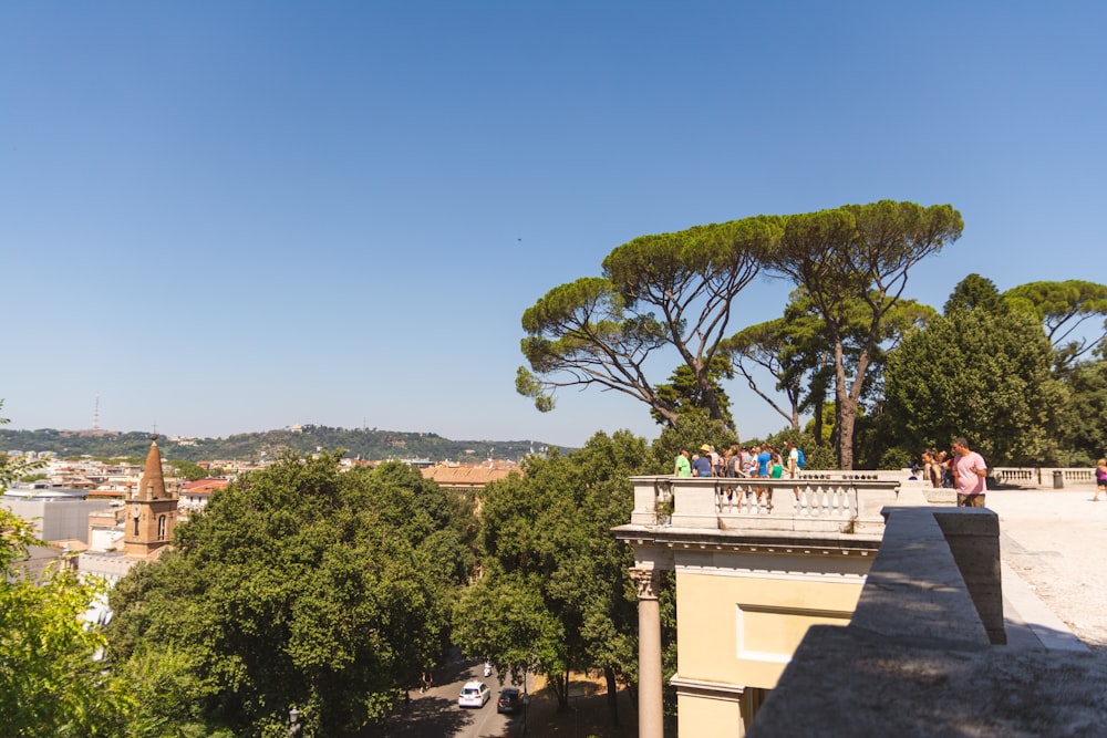 a group of people standing on top of a roof