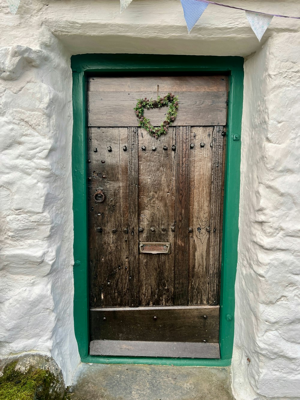 a wooden door with a wreath on it