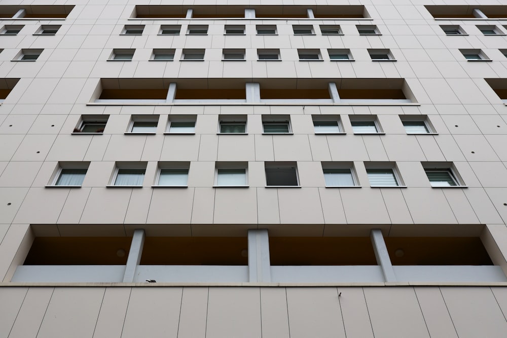 a tall white building with lots of windows