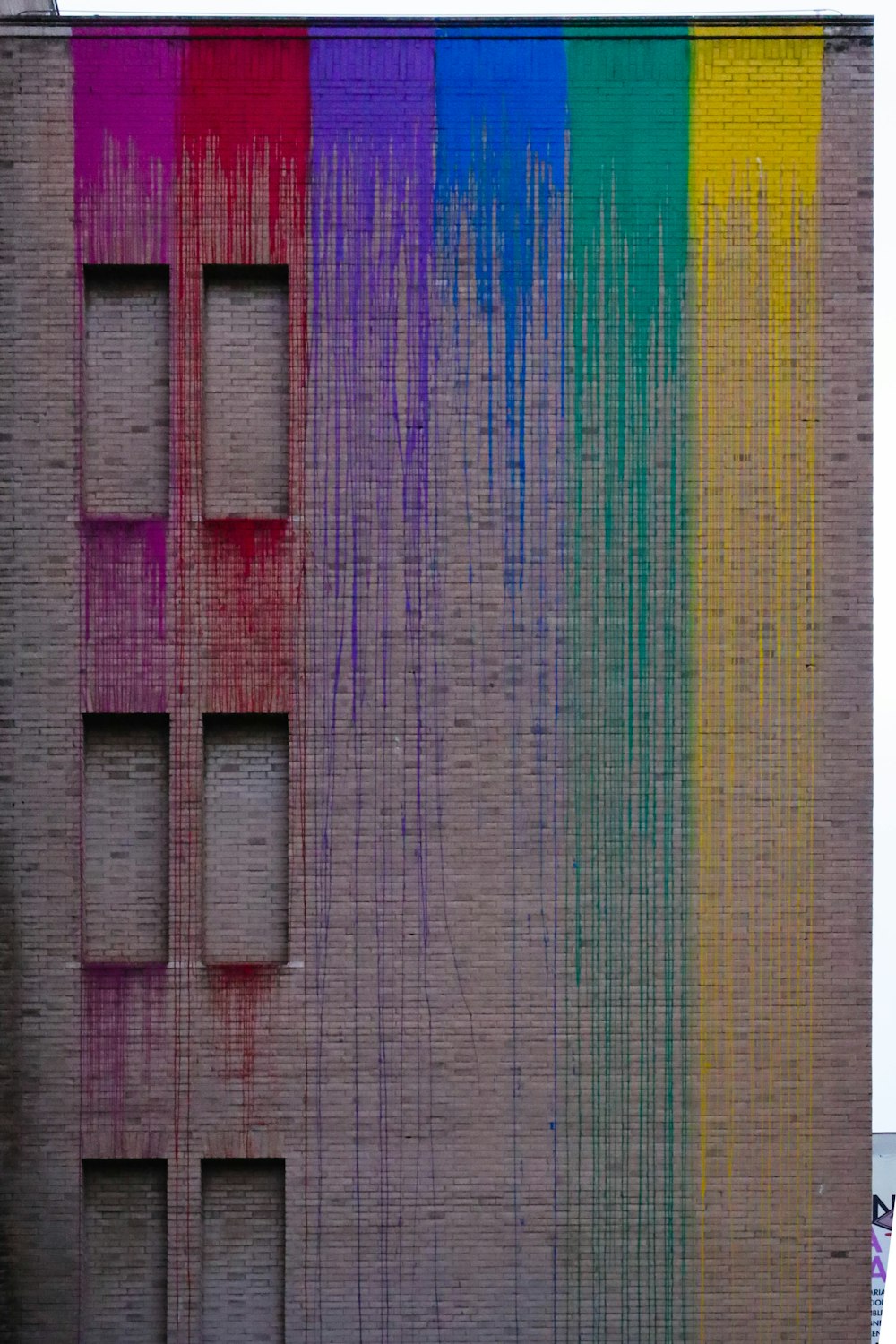 Un edificio con un arco iris pintado en el costado