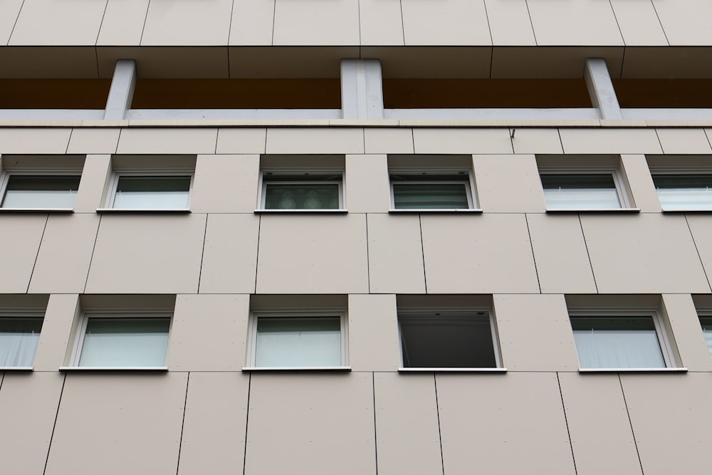 a tall building with many windows and a clock