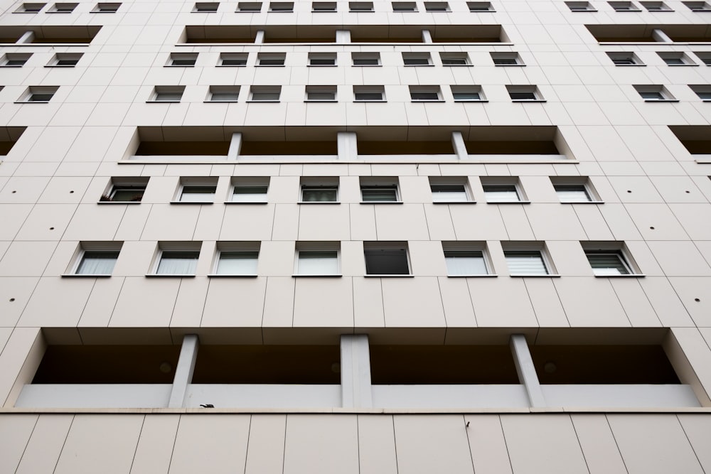 a tall white building with lots of windows