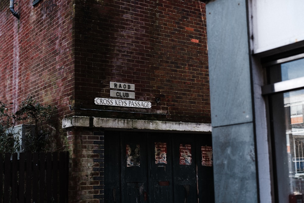 a brick building with two street signs on it