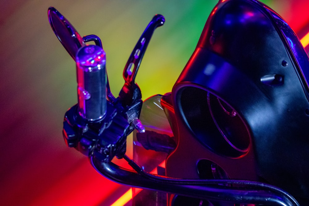 a close up of a bike handlebar with a neon background