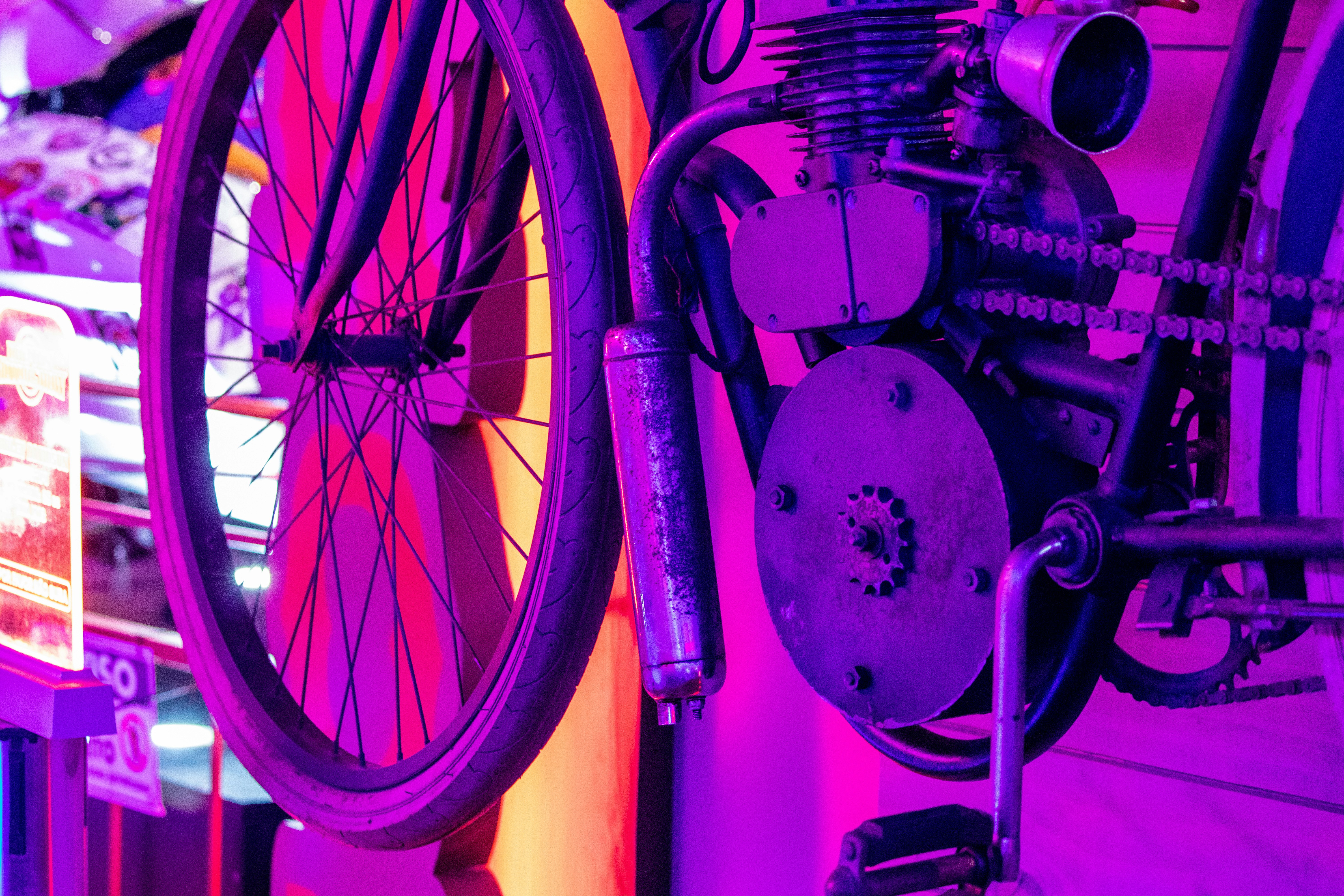 a purple bike is hanging on a wall