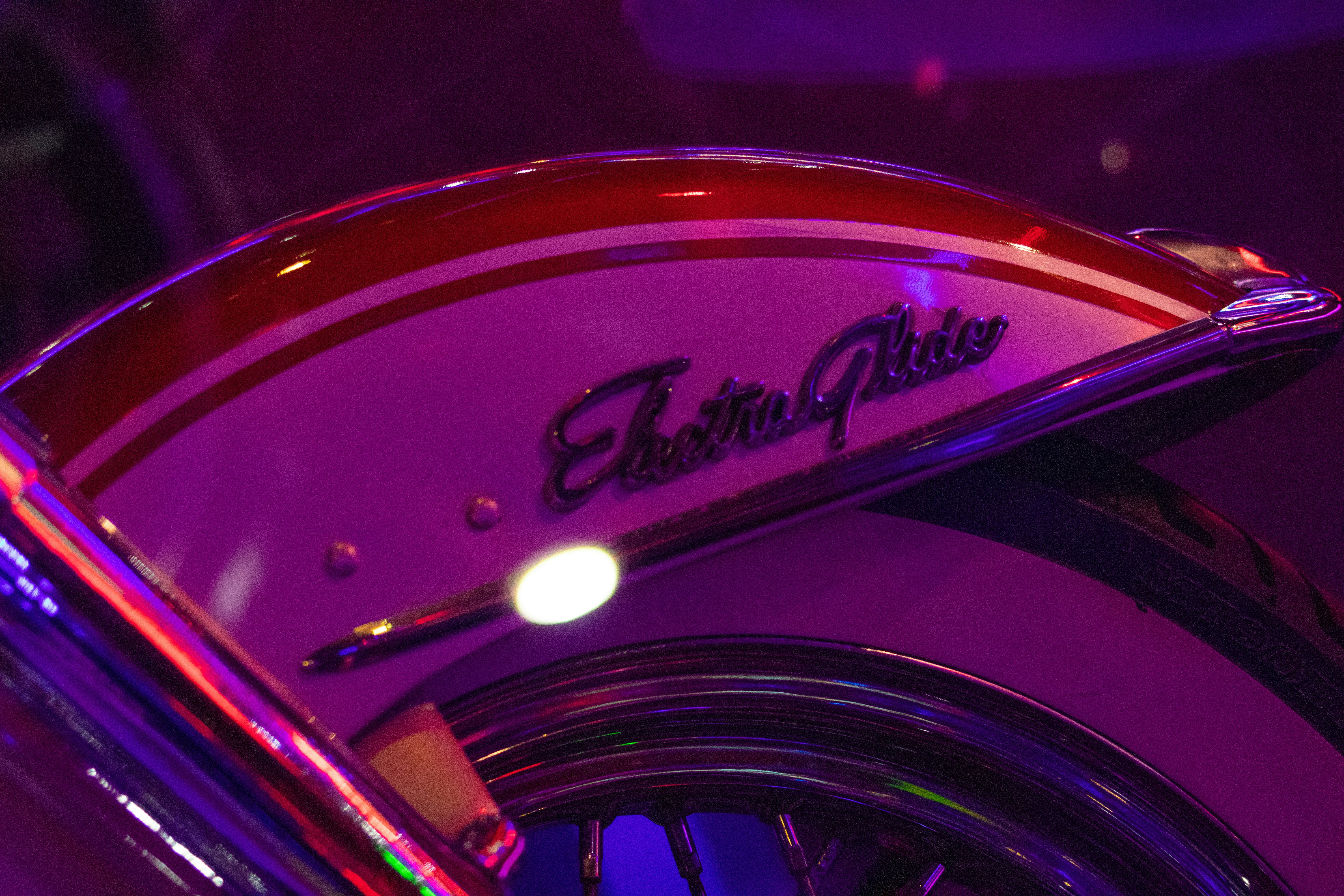 a close up of a motorcycle with a purple background