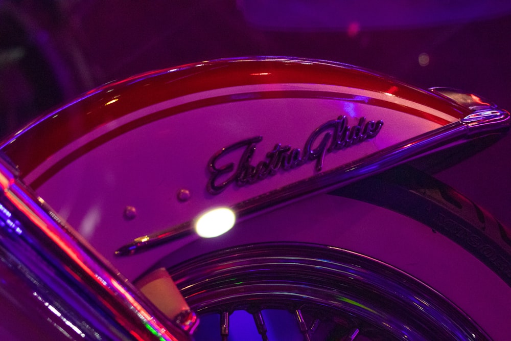 a close up of a motorcycle with a purple background