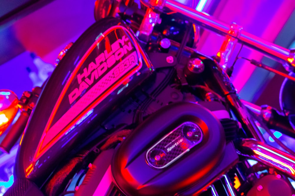 a close up of a motorcycle with a purple light
