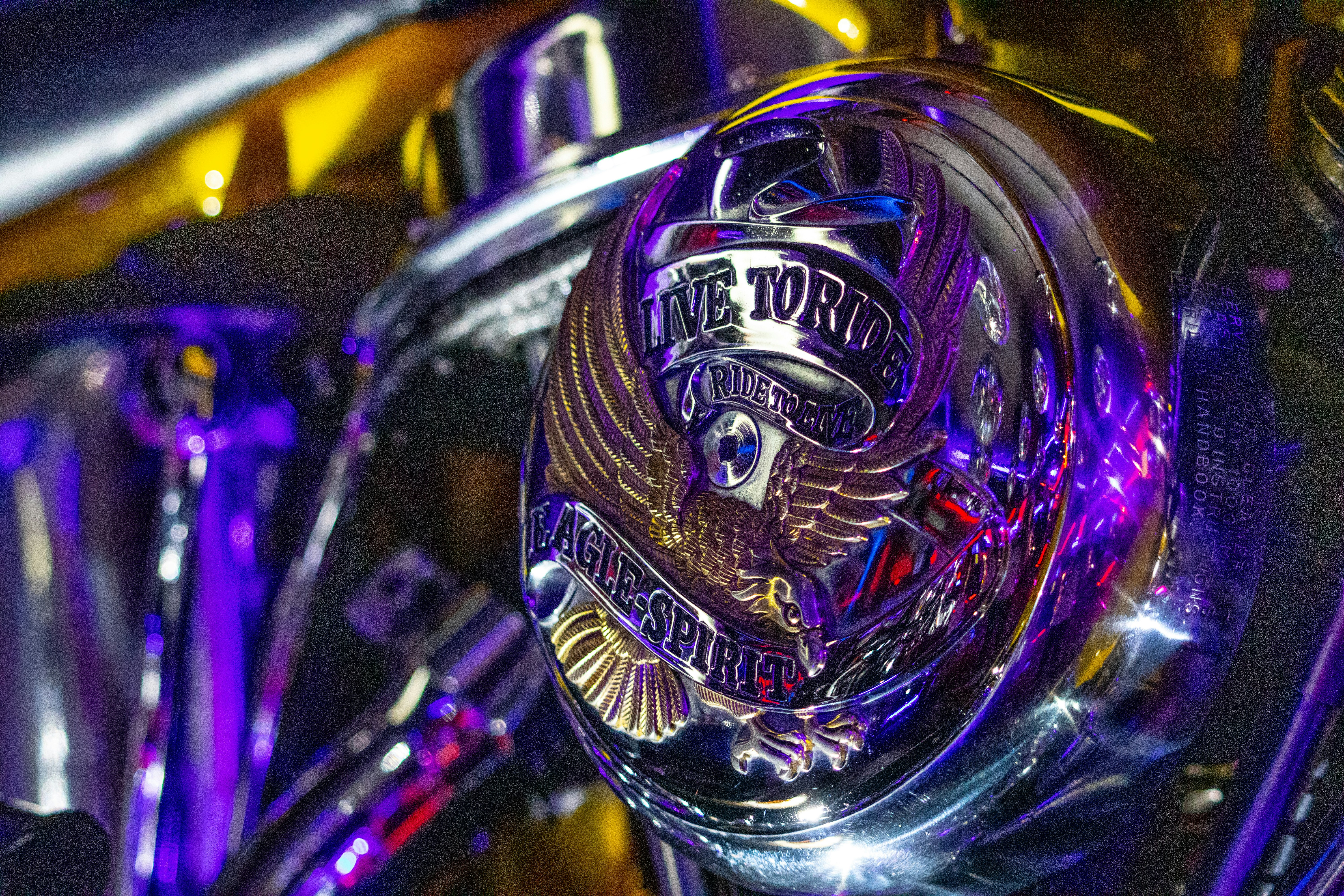a close up of a motorcycle with a purple light