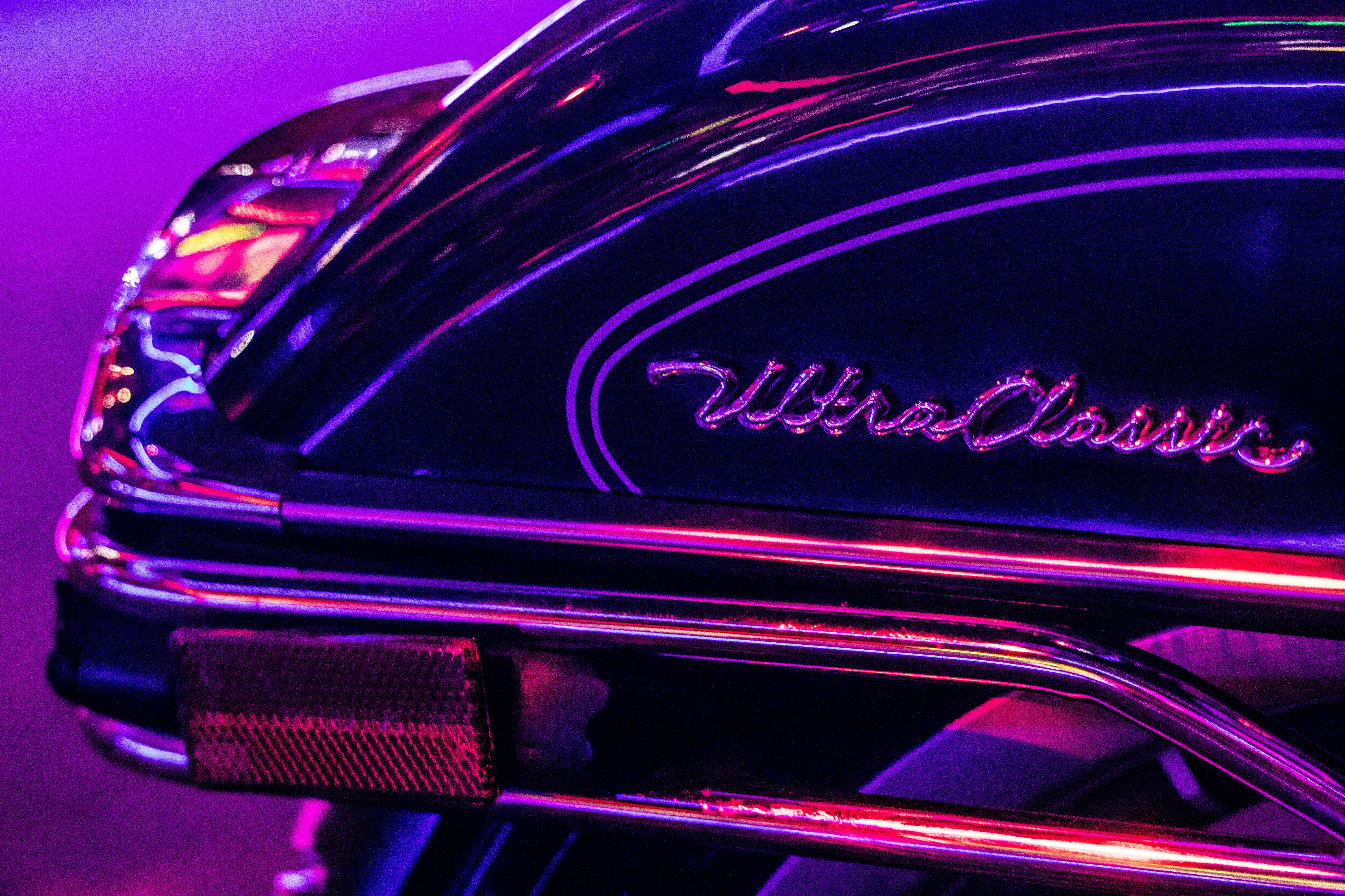 a close up of a motorcycle with a purple light