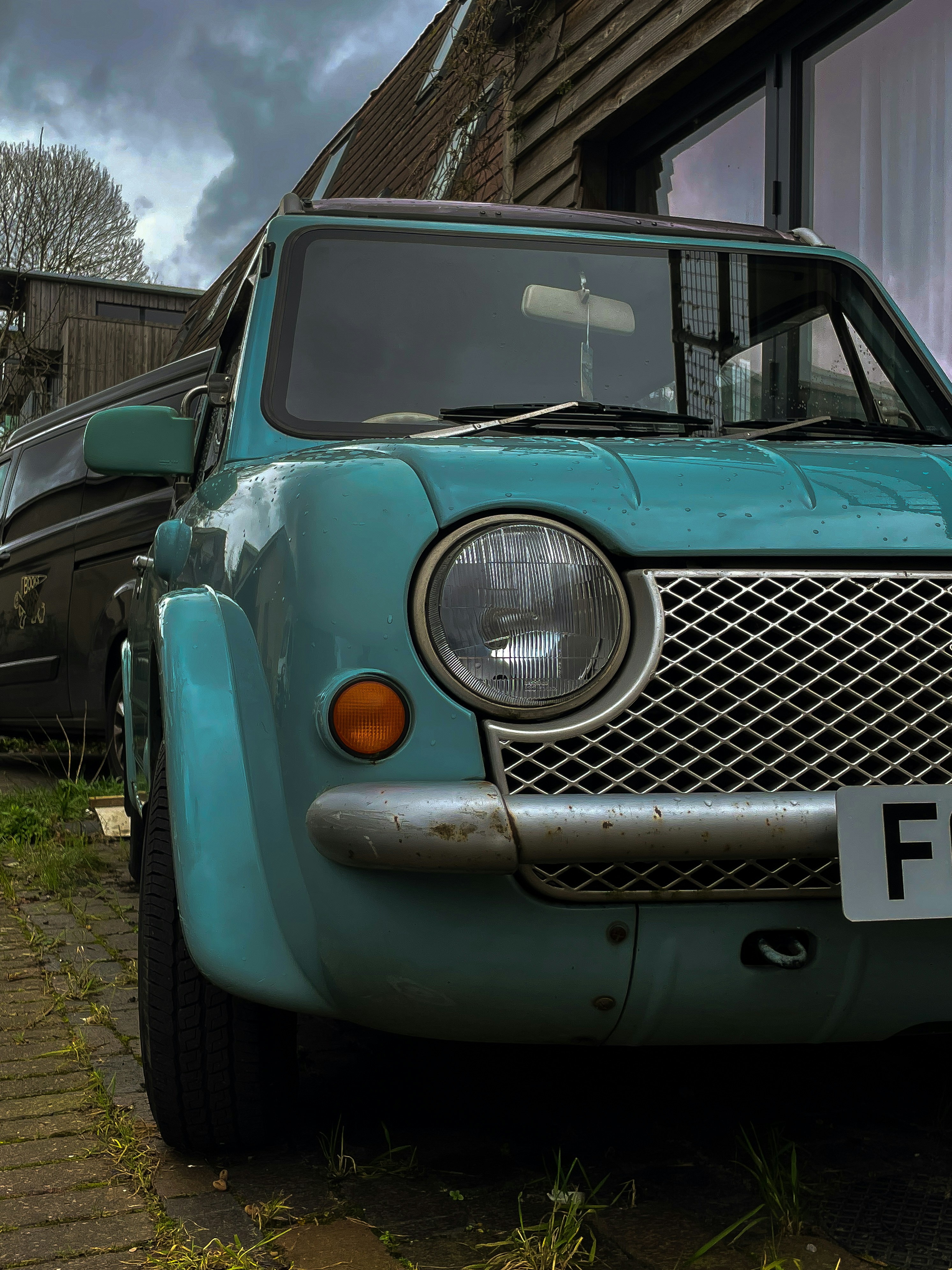 a blue truck parked in front of a building