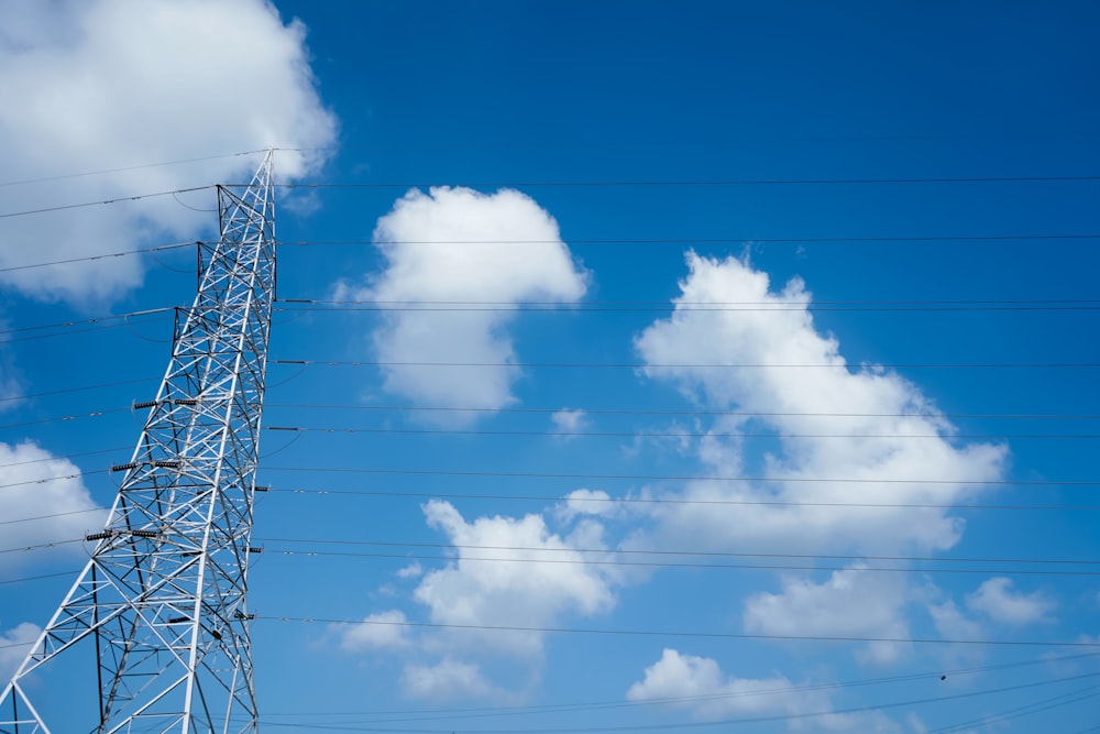 a high voltage power line against a blue sky