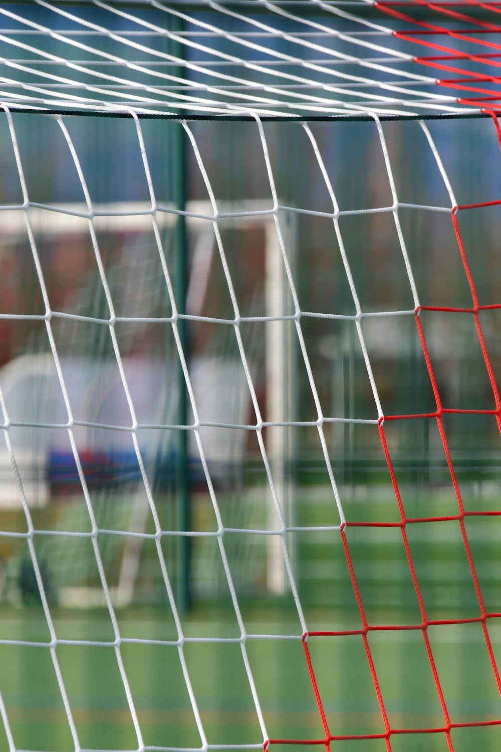 a close up of a soccer goal net with a blurry background