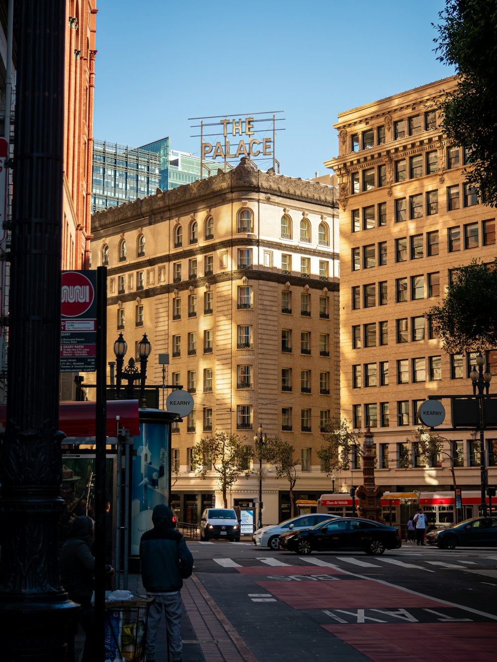 a city street with a tall building in the background