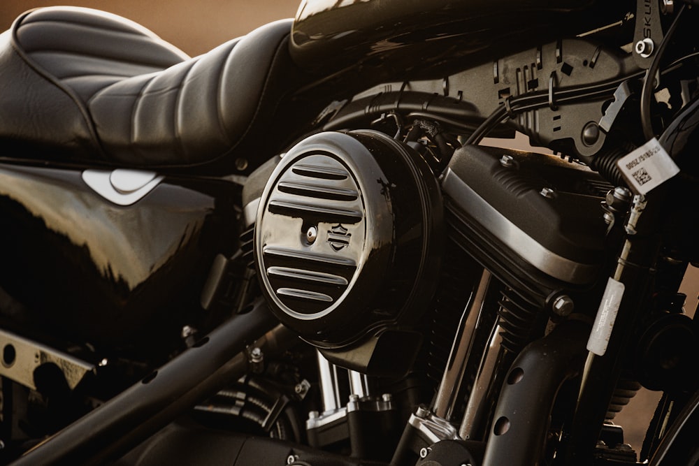 a close up of a motorcycle with a black leather seat