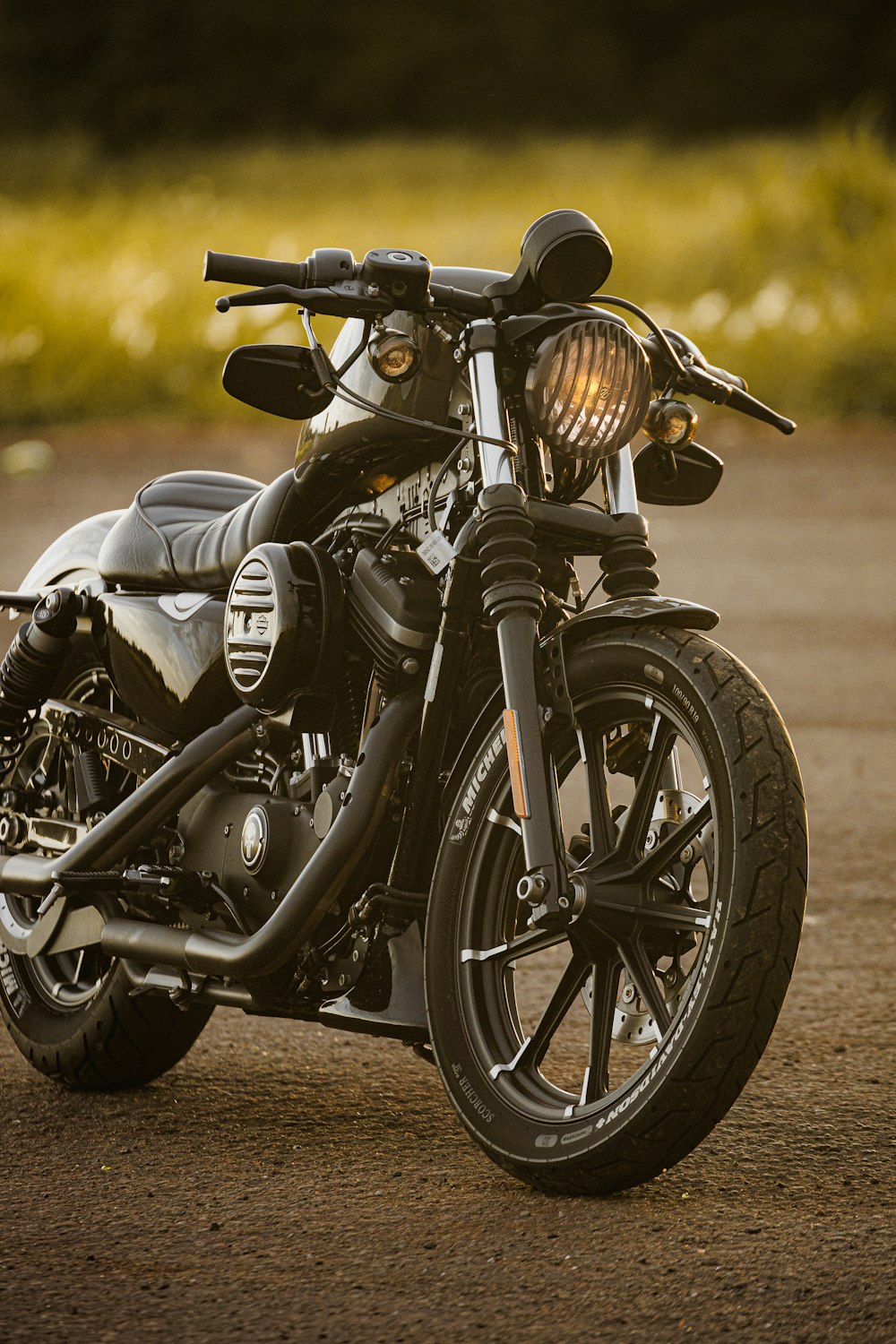 a black motorcycle parked on a dirt road