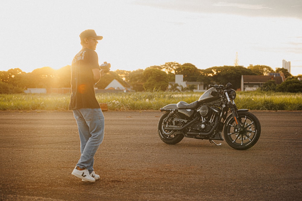 a man standing next to a parked motorcycle