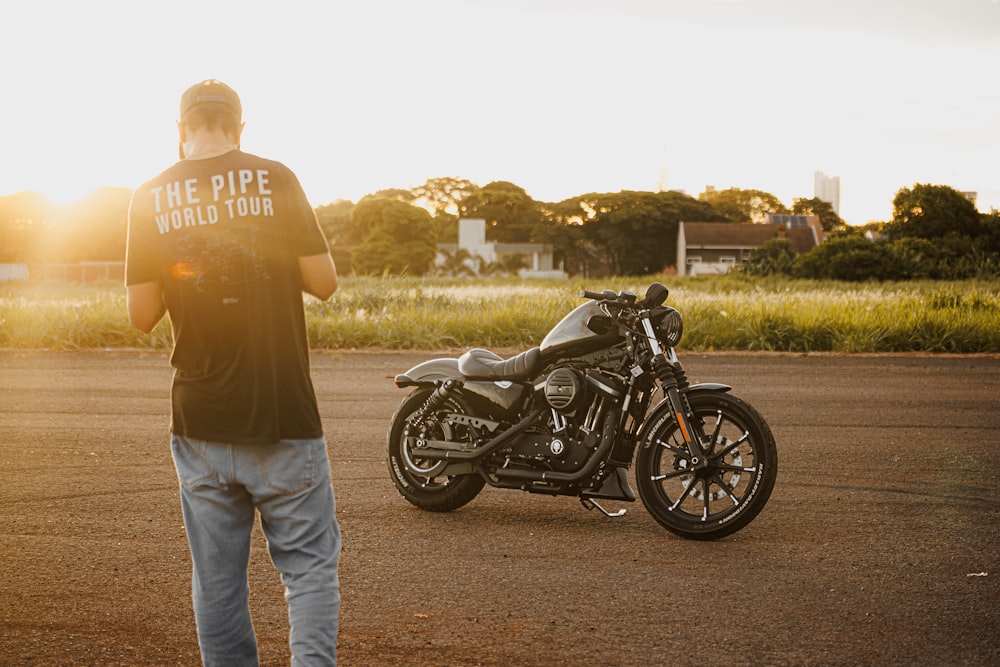 a man standing next to a parked motorcycle