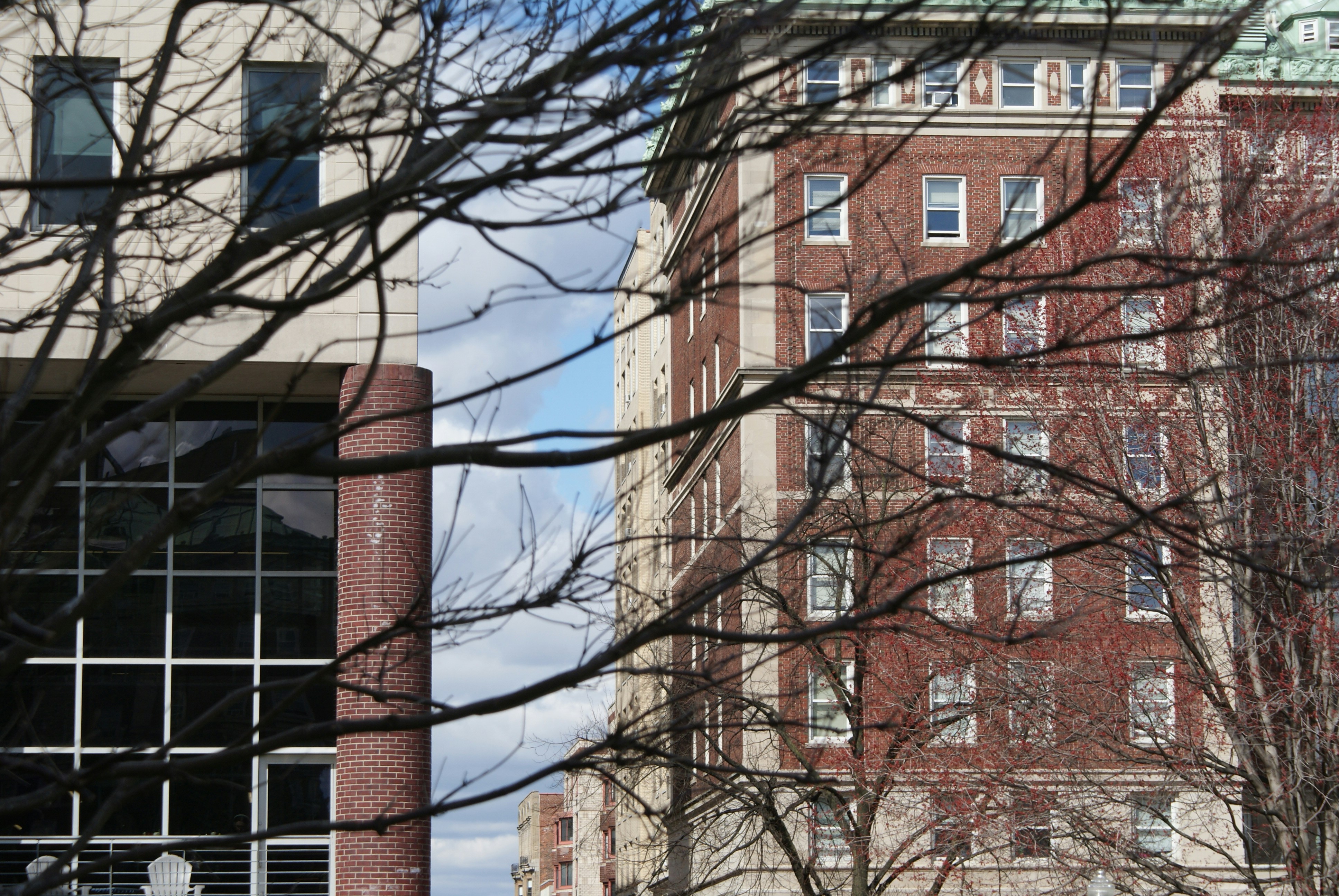a red stop sign sitting in front of a tall building