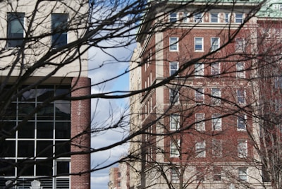 a red stop sign sitting in front of a tall building