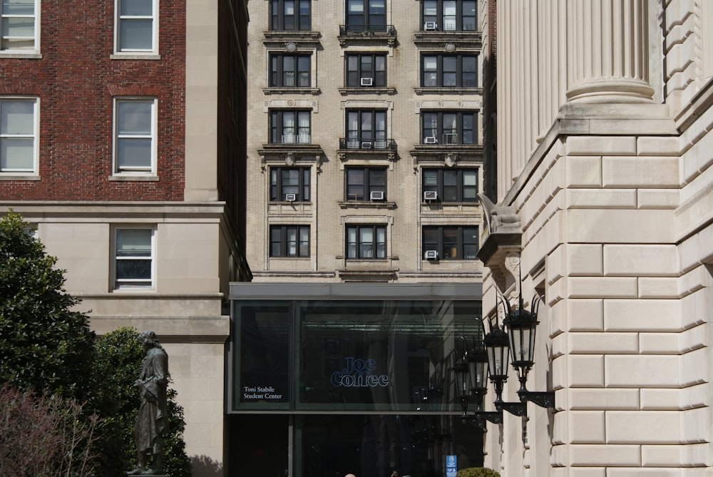 a couple of people sitting on a bench in front of a building