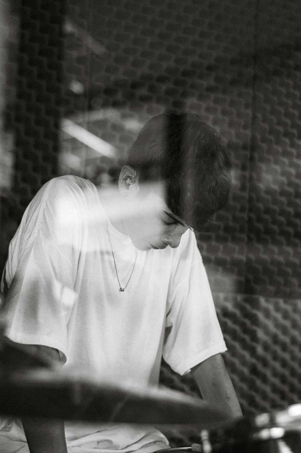 a black and white photo of a man in a recording studio