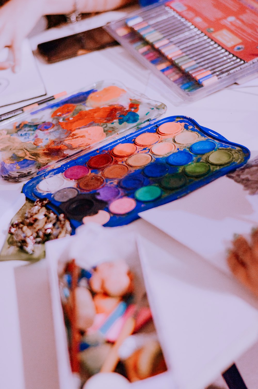 a table topped with lots of different colored paints