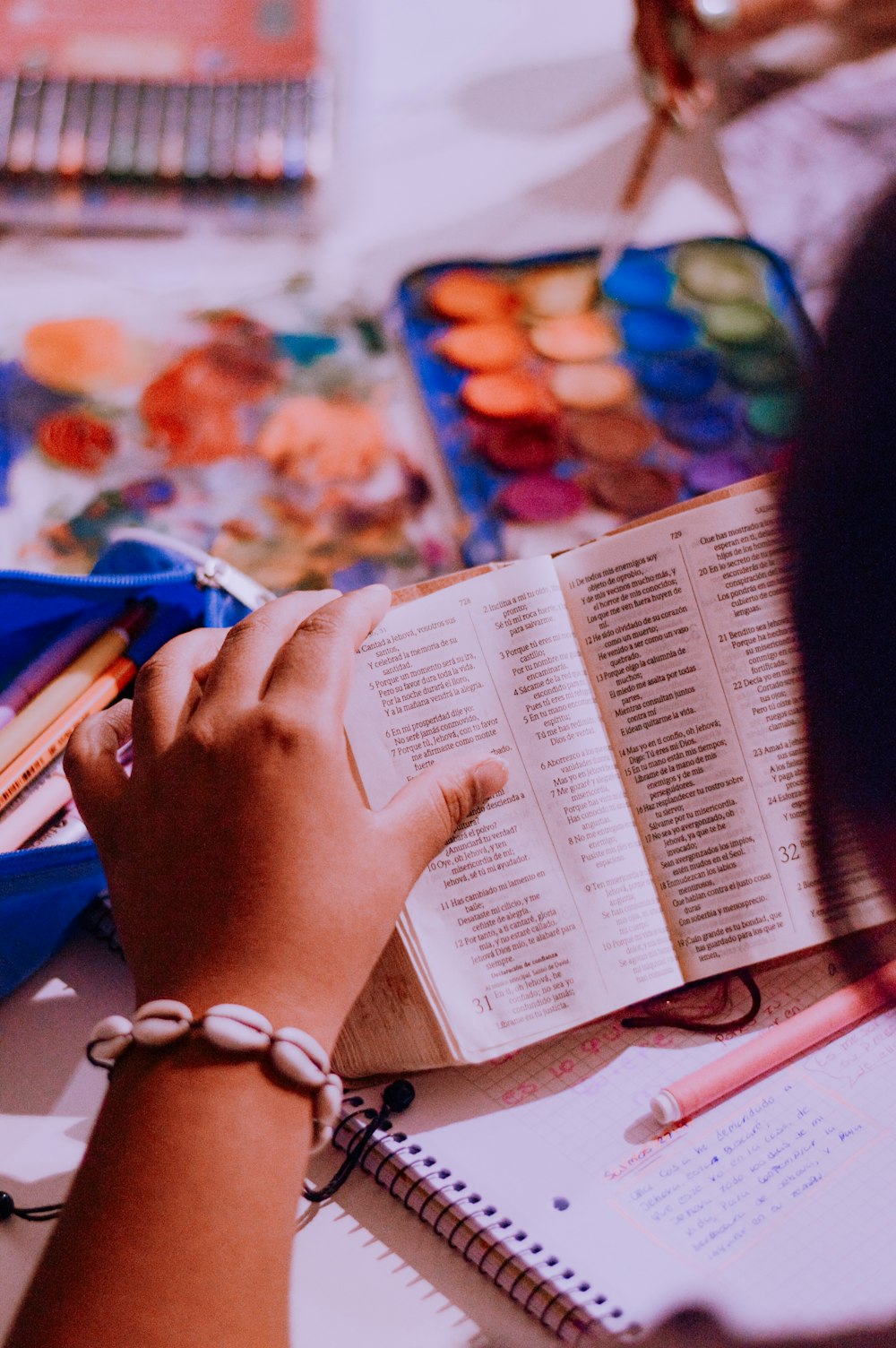 a person sitting at a table with a book