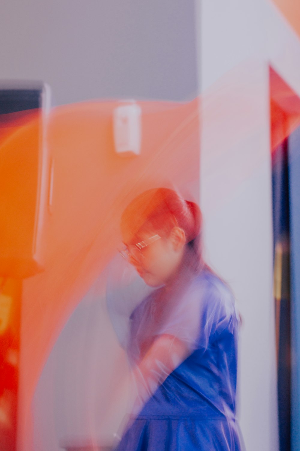 a blurry photo of a woman in a blue dress