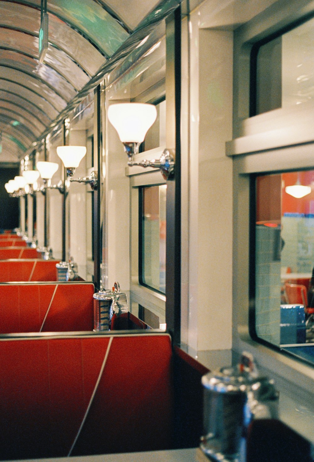 a train car with red seats and windows