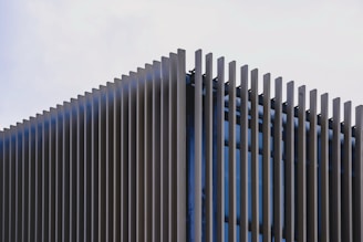 a building made of metal pipes against a blue sky