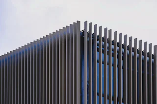 Modern black metal fence panels by Young Bros