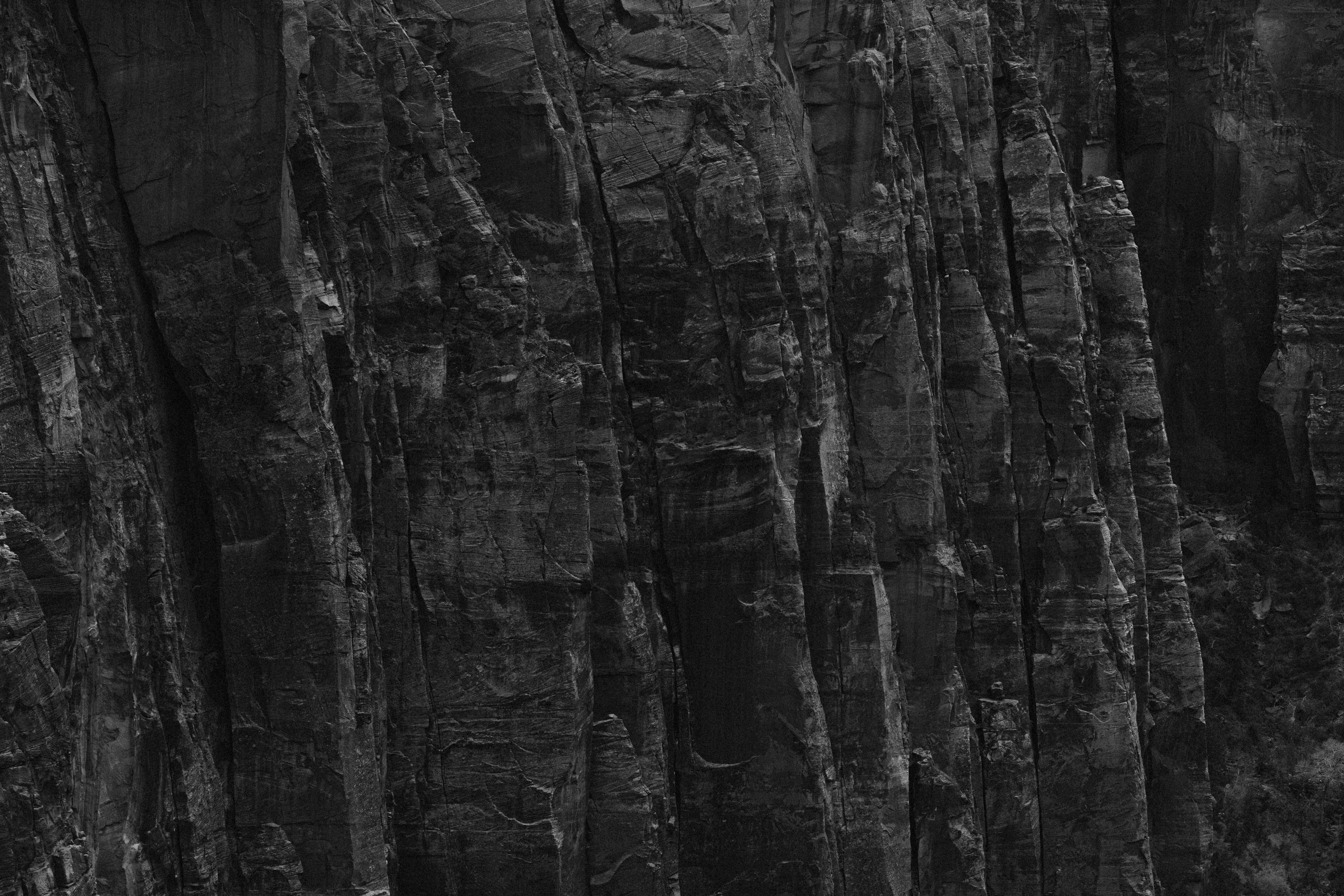 a black and white photo of a mountain side