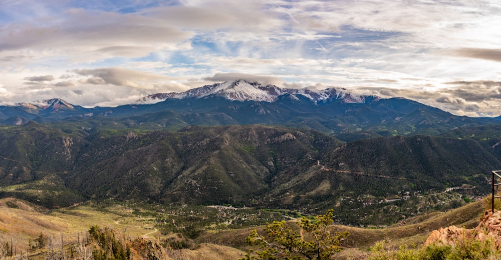 a scenic view of a mountain range with mountains in the background