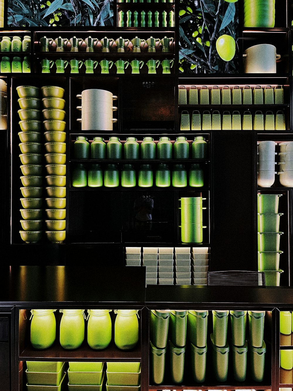 a shelf filled with lots of green vases