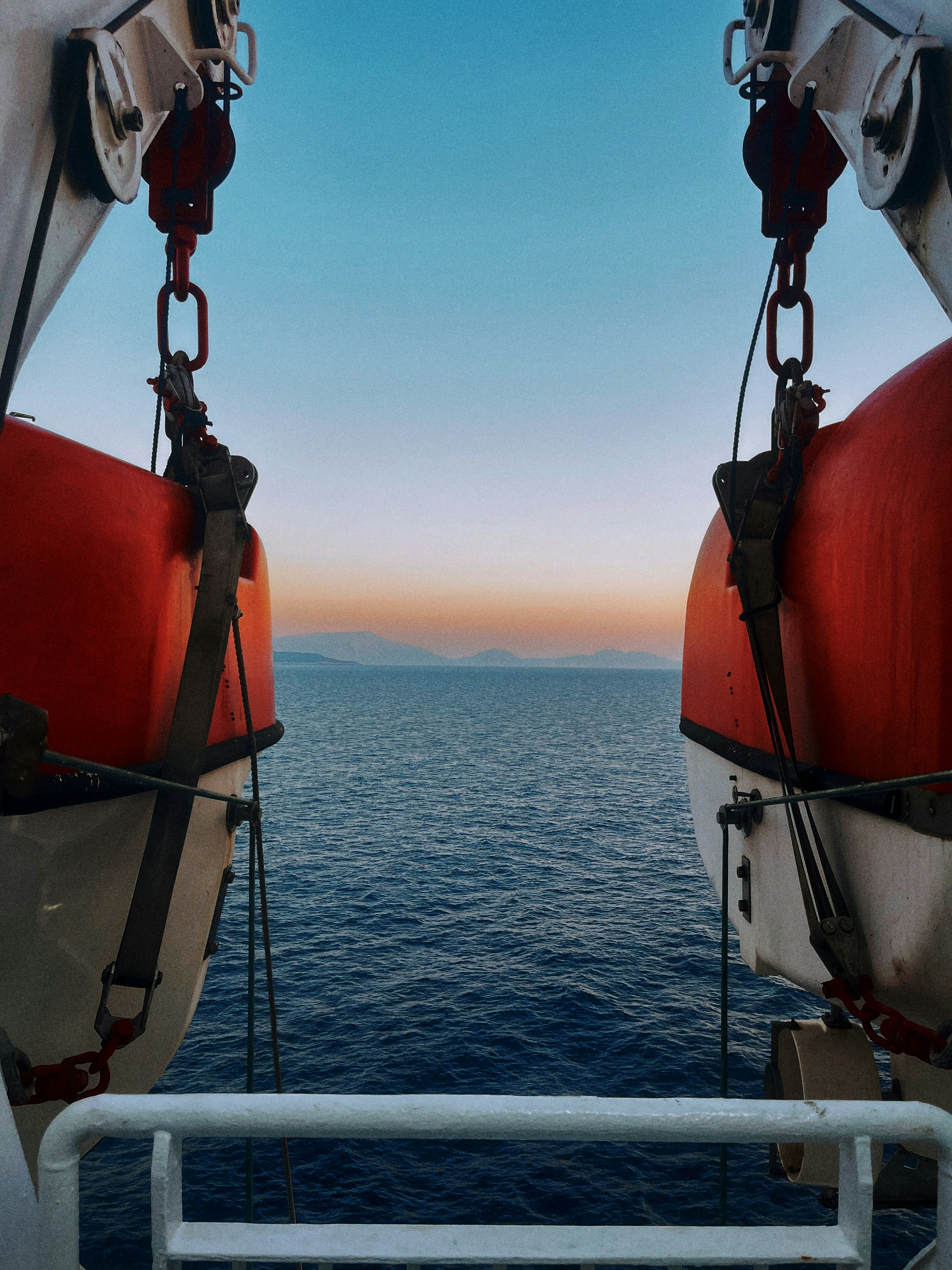 two red and white buoys on a boat in the ocean