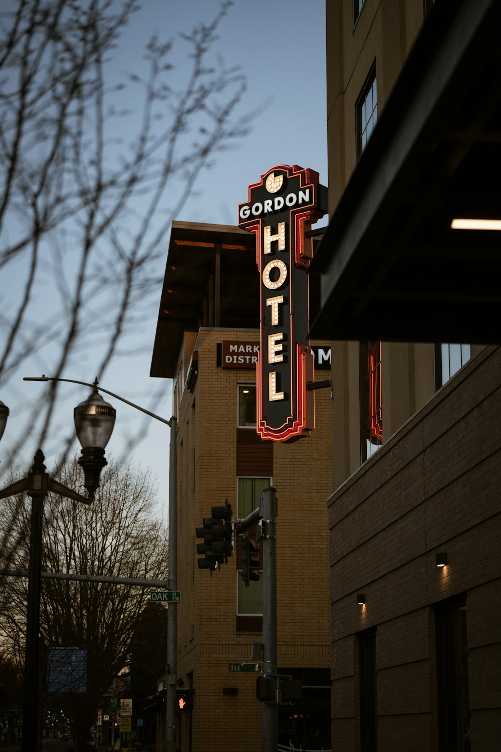 a neon hotel sign on the side of a building