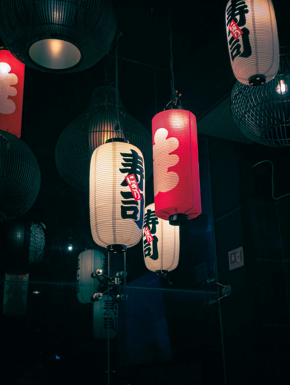 a group of chinese lanterns hanging from the ceiling