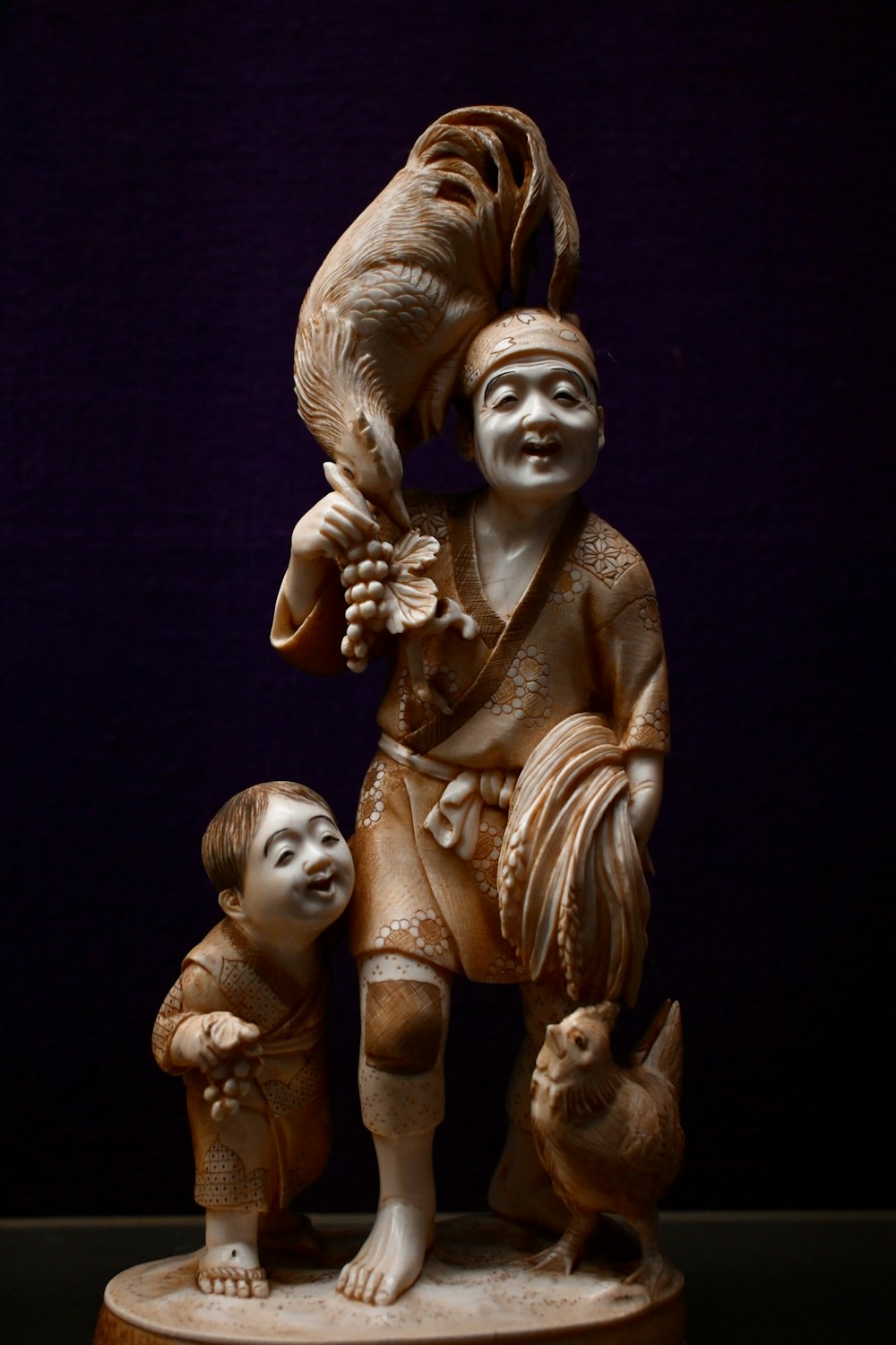 a statue of a boy and a girl holding a bird